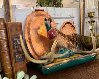 Antlers, jade grapes, old books, statuary and copper