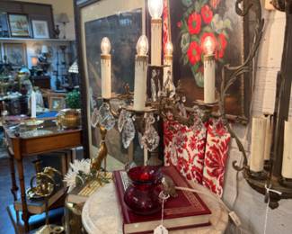 marble topped table, candlesticks, poppy framed art, vintage brass galore.