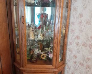 Curio cabinet with birds and bells