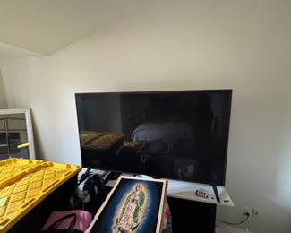 Flat screen TV, tv stand - yellow bins and painting not included