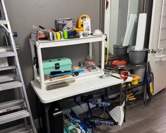 Bike rack, box fan, measuring tapes, tackle box, brushes, garden shears, mirror