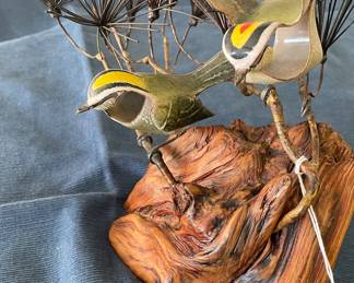 Close up of Brumm chickadees in pine sculpture enamel over copper with Burl wood base
