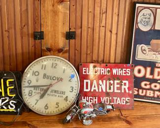 Wolverine Shocks light up neon sign $50
Bulova large round, metal framed clock $25sold
DANGER Electric Wires / High Voltage red sign $20 sold; Barney Oldfield & his golden submarine framed $25 sold
