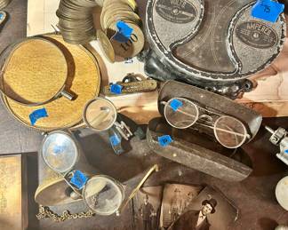 Vintage glasses & case $10 ea
Vintage glasses with sides $25
Tin antiq photos 3 for $25
Small magnifier with clip & stand $ 15
Larger magnifying glass with pouch $15
minature level $15
$75Weston Electrical Instrument Car Volt Amp Meter Dash Gauge used from 1880-1902. 
The gauge was used in early electric cars to monitor the car's lead-acid battery by measuring both volts and amperes
Coat check brass number ring $25 sold