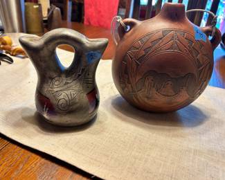 Native American pottery 2 sided Vase With purple hue $25
Signed Native American etched clay thermos $95