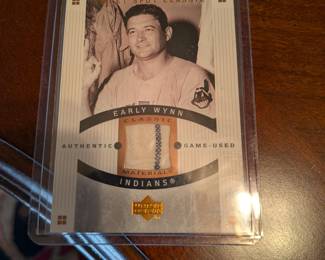 A unique piece of baseball history! This card contains a piece of authentic game-used material from Hall of Famer Early Wynn's pants. The relic is authenticated and guaranteed by The Upper Deck Company, making it a great addition to any collector's set.