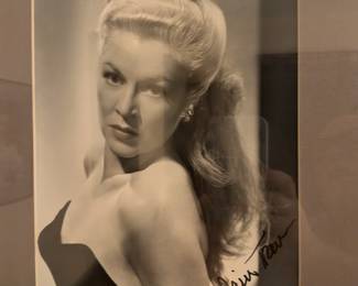 Framed black-and-white photo with a signature that appears to be from Claire Trevor, an Academy Award-winning actress known as the "Queen of Film Noir."
