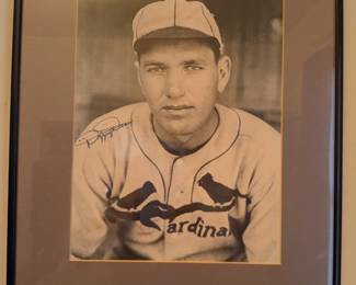 This is a striking black and white portrait of the legendary St. Louis Cardinals pitcher and Hall of Famer, Dizzy Dean. The photograph features an authentic-looking signature from the "Gashouse Gang" ace. This is an incredible find for any baseball fan or serious collector of baseball history, beautifully presented in a classic frame.
