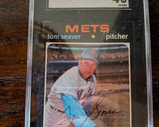 A unique piece of vintage baseball history! This card of legendary Hall of Famer Tom Seaver is from the iconic 1971 Topps set and is graded SGC 4. The card features a hand-signed autograph from "Tom Terrific" himself. While the signature is not certified on the slab, it's a fantastic piece for any New York Mets fan or collector of vintage baseball cards.