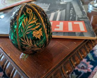 A beautiful and comprehensive collection of seven decorative glass eggs in the classic Fabergé style. Handcrafted in Russia, these eggs feature intricate etched designs in a variety of vibrant colors. They are perfect for a curio cabinet, as unique decorative pieces, or as a gift for a collector of classic Russian art.