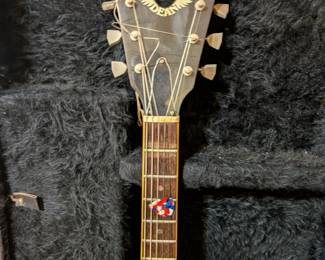 A classic electric guitar for any rock or metal fan! This is an iconic V-shaped guitar by the well-known American manufacturer Dean. The guitar has a rich, deep red finish and comes with a durable, form-fitting hard case. It is in used but functional condition, ready for a musician to tune it up and play. A great find for a collector, a new player, or a professional looking for a reliable stage guitar.