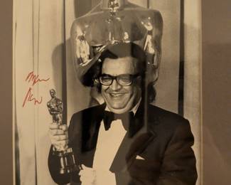An exceptional piece of Hollywood history! This framed black-and-white photo captures the acclaimed actor Ray Milland with his Academy Award for The Lost Weekend. The photo features an authentic-looking signature from the classic film star. A perfect piece for any film buff or collector of classic movie memorabilia.
