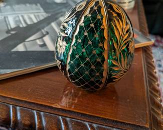 A beautiful and comprehensive collection of seven decorative glass eggs in the classic Fabergé style. Handcrafted in Russia, these eggs feature intricate etched designs in a variety of vibrant colors. They are perfect for a curio cabinet, as unique decorative pieces, or as a gift for a collector of classic Russian art.