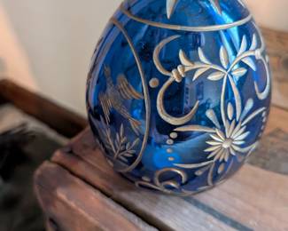 A beautiful and comprehensive collection of seven decorative glass eggs in the classic Fabergé style. Handcrafted in Russia, these eggs feature intricate etched designs in a variety of vibrant colors. They are perfect for a curio cabinet, as unique decorative pieces, or as a gift for a collector of classic Russian art.