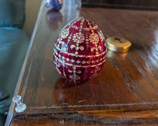 A beautiful and comprehensive collection of seven decorative glass eggs in the classic Fabergé style. Handcrafted in Russia, these eggs feature intricate etched designs in a variety of vibrant colors. They are perfect for a curio cabinet, as unique decorative pieces, or as a gift for a collector of classic Russian art.