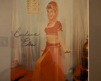 Framed color photo with a signature that appears to be from Barbara Eden, an actress famous for her role as Jeannie in the sitcom I Dream of Jeannie.