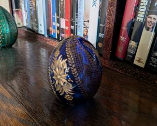 A beautiful and comprehensive collection of seven decorative glass eggs in the classic Fabergé style. Handcrafted in Russia, these eggs feature intricate etched designs in a variety of vibrant colors. They are perfect for a curio cabinet, as unique decorative pieces, or as a gift for a collector of classic Russian art.