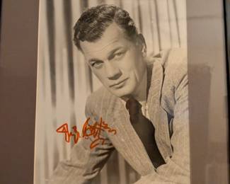 Framed black-and-white photo with a signature that appears to be from Joseph Cotten, a versatile actor known for his collaborations with Orson Welles in films like Citizen Kane and The Third Man.
