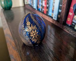 A beautiful and comprehensive collection of seven decorative glass eggs in the classic Fabergé style. Handcrafted in Russia, these eggs feature intricate etched designs in a variety of vibrant colors. They are perfect for a curio cabinet, as unique decorative pieces, or as a gift for a collector of classic Russian art.