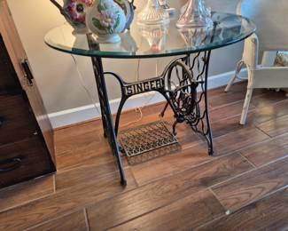 Glass top table with antique singer sewing machine base