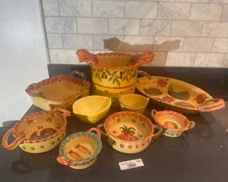 Assorted colorful Mexican pottery bowls and serving pieces.