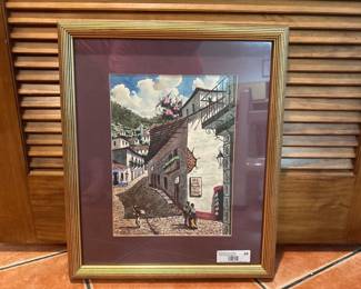 Framed painting of Mexican street scene with figures.