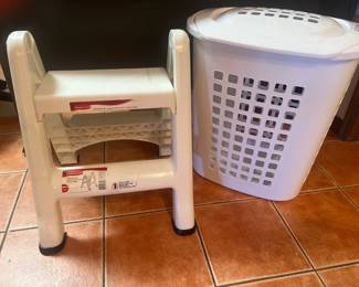 Handy plastic folding step stool and white laundry hamper—lightweight and durable.