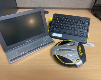 Assorted lot of DVD player, ZAGG Bluetooth keyboard, and Sony Sports CD Discman.