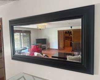 Modern wall mirror with bold black frame, oversized rectangular shape