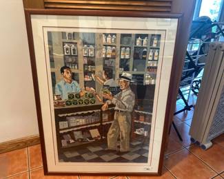 Framed colorful print of shop interior scene.
