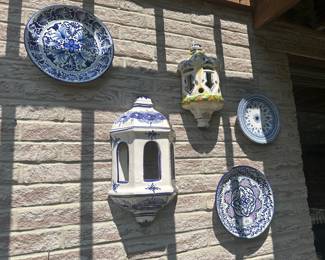 Decorative talavera-style ceramic plates and lanterns in blue and white tones.