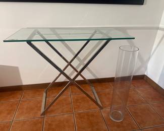 Sleek glass top console table with polished chrome X-frame foldable base