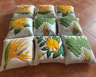 Set of 9 handmade Hawaiian-style quilted pillow covers with vibrant floral designs.