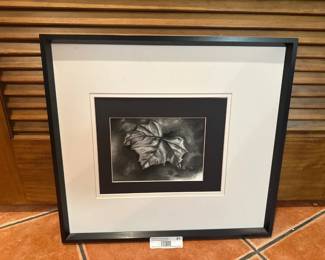 Framed charcoal leaf artwork in black and white.
