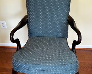 Blue upholstered armchair with wood accents