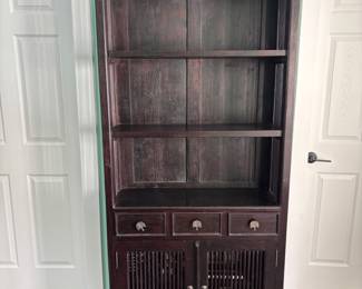 Large dark wood bookcase. Matches three drawer cabinet (pictured) with palm hardware.