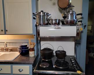 Solid Copper Pot Rack, Vintage Revere ware, Oneida Stainless Cookware and Cast Iron. (stove is not for sale.)