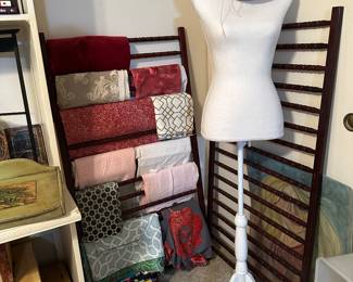 Two wooden racks, designer, fabrics, white velvet dress form on stand