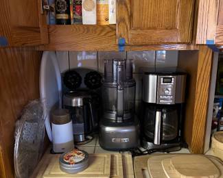 Cuisinart food processor, accessory box in previous photo, sets of cutting boards, Cuisinart coffee maker, teas, etc.
