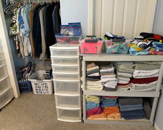 Towels, beach towels, two bins like new kids swimwear, more storage containers, men’s clothing