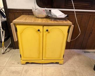 vintage yellow cabinet with fold down wings and great storage