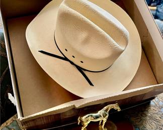 MULTIPLE COWBOY HATS.