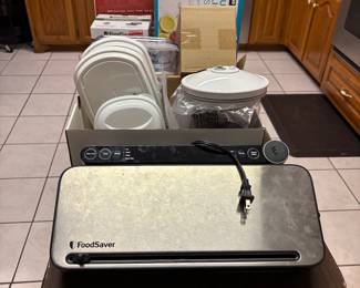 Food Saver Vacuum Sealer $40, lots of Food Saver accessories and case of bags $20. Ziplock storage containers--various sizes underneath table
