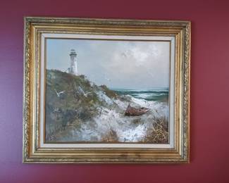 Nautical beach scene with the lighthouse picture in a frame