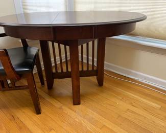very nice 40" round dark wood table, shown with a 10" leaf inserted with one additional 10" leaf available + 6 chairs