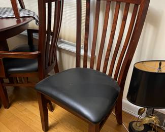 very nice 40" round dark wood table, shown with a 10" leaf inserted with one additional 10" leaf available + 6 chairs