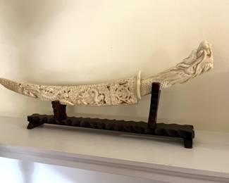 carved horn knife handle and scabbard on stand