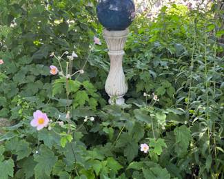 lots of garden objects, including several gazing balls