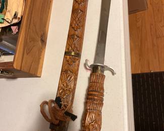 sword with carved handle and scabbard