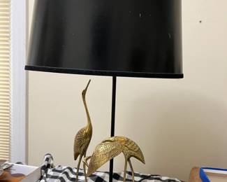 vintage lamp with brass cranes on base and black shade